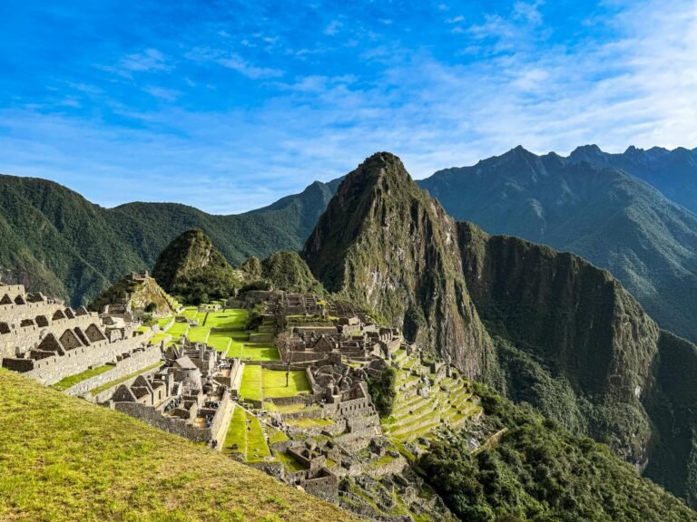 A breathtaking view of the ancient Machu Picchu ruins under a clear blue sky in Peru.