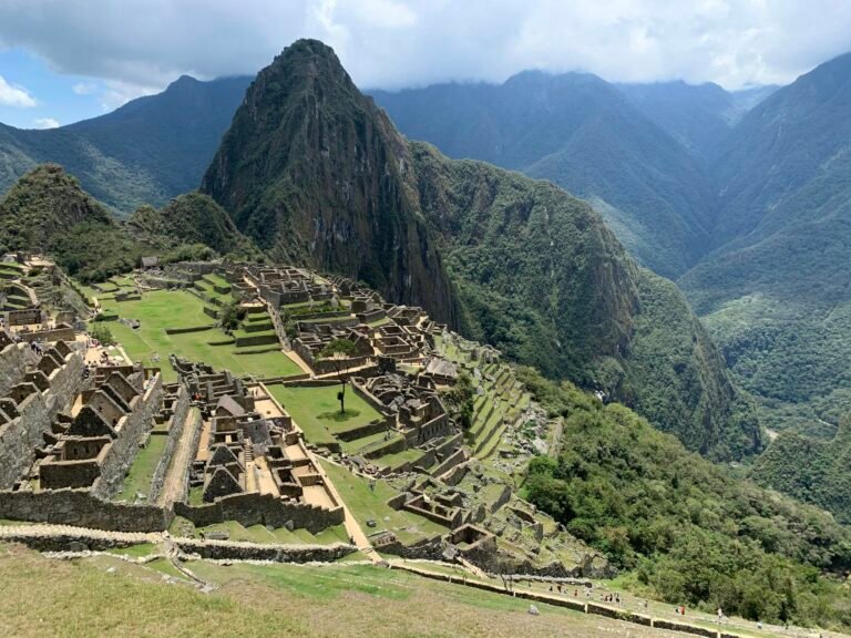 Explore the majestic ruins of the ancient Inca citadel of Machu Picchu set against the scenic Peruvian mountains.